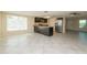 Well-lit kitchen offering stainless steel appliances, an island, and neutral tile flooring at 10118 Hickory Hill, Port Richey, FL 34668