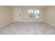 Inviting living room featuring neutral tile flooring, natural light, and a welcoming atmosphere at 10118 Hickory Hill, Port Richey, FL 34668