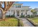 Charming two-story home with a welcoming porch, swing, beautiful landscaping, and a brick walkway at 120 25Th N Ave, St Petersburg, FL 33704