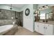 Bright bathroom boasts a soaking tub, tiled walk-in shower, and modern fixtures, perfect for relaxation at 14214 Quintessa Ln, Lithia, FL 33547