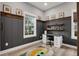Bright bedroom featuring wainscoting, decor shelves, a large window and a modern desk at 14214 Quintessa Ln, Lithia, FL 33547