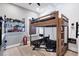Fun bedroom featuring a bunk bed with a race car driving game and built in shelves for car collections at 14214 Quintessa Ln, Lithia, FL 33547