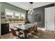 Elegant dining room with wood floors, a large dining table, a bar area, and a wine rack at 14214 Quintessa Ln, Lithia, FL 33547