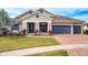 Charming single-Gathering home with a well-manicured lawn and a three-car garage at 14214 Quintessa Ln, Lithia, FL 33547
