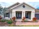 Charming single-story home featuring a covered front porch, well-maintained landscaping and an attached garage at 14214 Quintessa Ln, Lithia, FL 33547