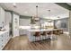 Open-concept kitchen with stainless steel appliances, a large island, bar seating, and adjacent dining area at 14214 Quintessa Ln, Lithia, FL 33547