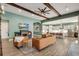 Spacious living room with hardwood floors, fireplace, leather furniture, and open to the kitchen at 14214 Quintessa Ln, Lithia, FL 33547