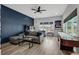 Entertainer's living room featuring a games, large windows, and a sleek modern sectional at 14214 Quintessa Ln, Lithia, FL 33547