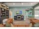 Open living room boasts built-in bookcases, a cozy fireplace, and seamless flow, perfect for modern living at 14214 Quintessa Ln, Lithia, FL 33547