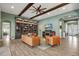 Open-concept living room with hardwood floors, a fireplace, built-in shelves, and comfortable seating at 14214 Quintessa Ln, Lithia, FL 33547