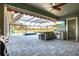 Enclosed outdoor kitchen featuring built-in grill, sink, and bar area, adjacent to the pool and patio at 14214 Quintessa Ln, Lithia, FL 33547