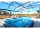 Beautiful in-ground pool and spa with a screened-in enclosure and plenty of space for entertaining at 14214 Quintessa Ln, Lithia, FL 33547