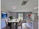 Modern dining room featuring a marble table, stylish chairs, and a view of the backyard at 6025 Florida S Cir, Apollo Beach, FL 33572