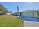 Charming single-story home featuring a well-manicured lawn and an attached garage at 6025 Florida S Cir, Apollo Beach, FL 33572