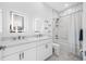 Bright bathroom features double sinks, marble floors, and modern bathtub/shower combination at 644 3Rd S Ave # 305, St Petersburg, FL 33701