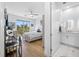 Bedroom boasts wood floors, ceiling fan, and a view from the sliding glass doors at 644 3Rd S Ave # 305, St Petersburg, FL 33701