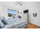 Bright bedroom with a large window, desk, ceiling fan, and warm hardwood floors at 644 3Rd S Ave # 305, St Petersburg, FL 33701