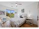 Cozy bedroom with a ceiling fan, large window, and stylish neutral-toned furniture at 644 3Rd S Ave # 305, St Petersburg, FL 33701