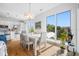 Sunlit dining area featuring a modern table, stylish chairs, and large windows with neighborhood views at 644 3Rd S Ave # 305, St Petersburg, FL 33701