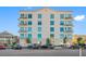 Modern six story condo building with balconies, manicured landscaping, and street parking at 644 3Rd S Ave # 305, St Petersburg, FL 33701