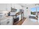 Modern kitchen with stainless steel appliances, white cabinets, and a view from the kitchen sink window at 644 3Rd S Ave # 305, St Petersburg, FL 33701