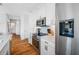 Bright white kitchen with stainless steel appliances, granite countertops, and hardwood floors at 644 3Rd S Ave # 305, St Petersburg, FL 33701