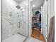 Spacious glass shower with marble tile and adjacent walk-in closet at 644 3Rd S Ave # 305, St Petersburg, FL 33701