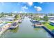 Scenic waterfront view of a canal lined with homes, docks, and boats under a bright blue sky with fluffy clouds at 8722 Elmwood Ln, Tampa, FL 33615