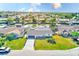 Aerial view of a waterfront community with many canals and the property featuring a well-manicured lawn and gray roof at 8722 Elmwood Ln, Tampa, FL 33615