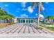 Expansive backyard showcasing a large patio, sunroom, fire pit, and palm trees for a tropical outdoor lifestyle at 8722 Elmwood Ln, Tampa, FL 33615