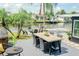 Waterfront backyard featuring an outdoor kitchen, dining, and a fire pit with lounge area at 8722 Elmwood Ln, Tampa, FL 33615