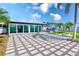 Extensive backyard with a patio, fire pit, and sunroom, offering ample space for outdoor activities and entertaining at 8722 Elmwood Ln, Tampa, FL 33615