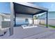 Backyard featuring a hot tub with a modern pergola, creating a tranquil and inviting outdoor oasis at 8722 Elmwood Ln, Tampa, FL 33615