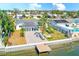 The backyard features a waterfront view, a tiled patio, and a fire pit area at 8722 Elmwood Ln, Tampa, FL 33615