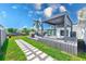 Relaxing backyard with a stylish pergola, hot tub, outdoor kitchen, and a lush lawn leading to waterfront views at 8722 Elmwood Ln, Tampa, FL 33615