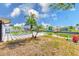 Waterfront backyard featuring a large patio, fire pit, and plenty of green space at 8722 Elmwood Ln, Tampa, FL 33615