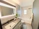 Bathroom with modern shower, vanity, and accent mirror at 8722 Elmwood Ln, Tampa, FL 33615