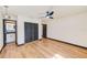 Bedroom featuring wood floors, fan, and modern doors at 8722 Elmwood Ln, Tampa, FL 33615