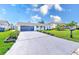 The driveway has been recently sealed and has manicured garden beds on either side at 8722 Elmwood Ln, Tampa, FL 33615