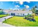 Beautifully landscaped home featuring a well-manicured lawn, tasteful plantings, and a two-car garage at 8722 Elmwood Ln, Tampa, FL 33615