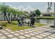 A waterfront fire pit with chairs and pavers offers a relaxing outdoor gathering space at 8722 Elmwood Ln, Tampa, FL 33615