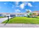 The manicured front yard has garden beds and lovely green grass at 8722 Elmwood Ln, Tampa, FL 33615