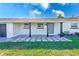 Beautiful front porch features stylish dark-colored columns and a stone-tiled entryway leading to the front door at 8722 Elmwood Ln, Tampa, FL 33615