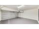Spacious and clean garage with an automatic door opener and gray painted floor at 8722 Elmwood Ln, Tampa, FL 33615