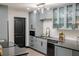 Modern kitchen featuring gray cabinets, stainless steel appliances, and sleek countertops at 8722 Elmwood Ln, Tampa, FL 33615