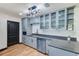 Stylish kitchen with stainless steel appliances, gray cabinets, and modern lighting fixtures at 8722 Elmwood Ln, Tampa, FL 33615