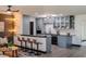 Modern kitchen with stainless steel appliances, island with seating, and stylish light fixtures at 8722 Elmwood Ln, Tampa, FL 33615