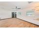 Bright living room with wood flooring, modern ceiling fan, black trim and plenty of natural light at 8722 Elmwood Ln, Tampa, FL 33615