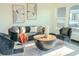 Well-lit living room with a cozy sofa, armchairs, and decorative artwork, creating an inviting atmosphere at 8722 Elmwood Ln, Tampa, FL 33615