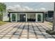 Rear exterior showcasing the expansive patio, modern design, and seamless indoor-outdoor living at 8722 Elmwood Ln, Tampa, FL 33615